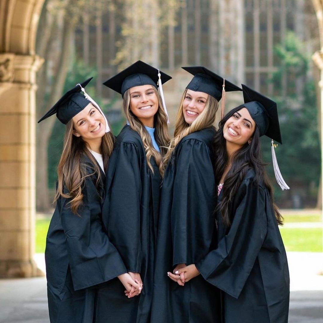 four graduates pose together