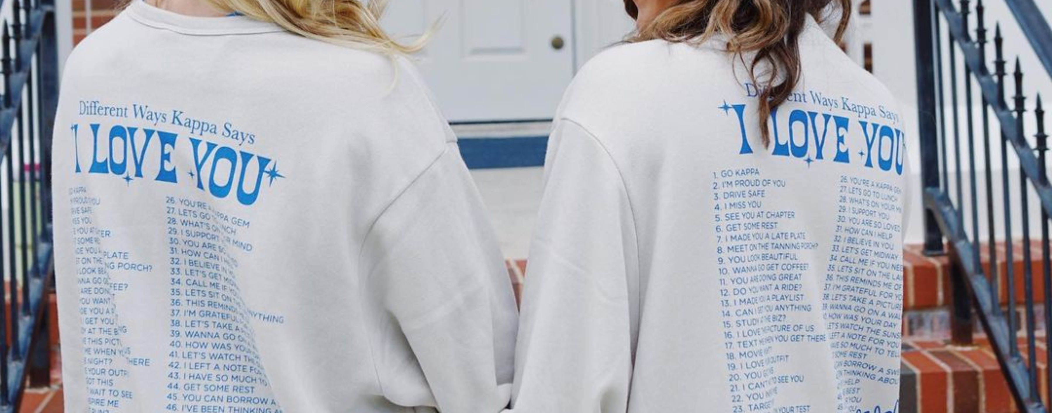 A photo of two Kappa sisters with backs facing the camera wearing t-shirts that say "different ways Kappa says I love you."